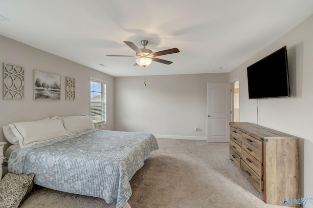 bedroom with ceiling fan and light colored carpet