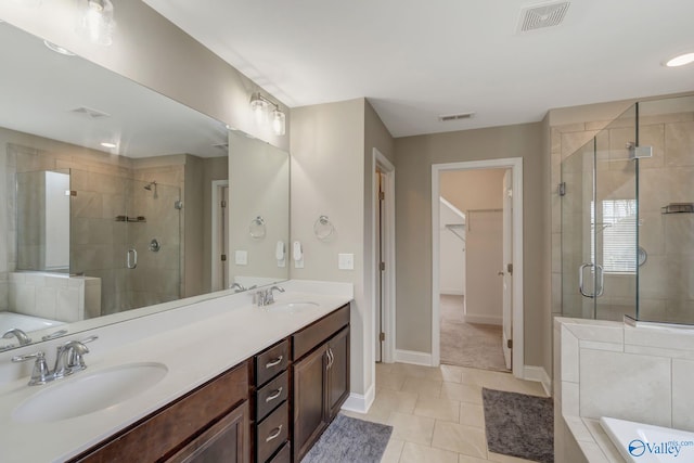 bathroom featuring vanity, tile patterned flooring, and plus walk in shower