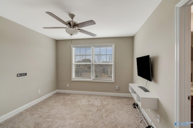 unfurnished office featuring ceiling fan and light colored carpet