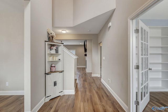 corridor featuring wood-type flooring