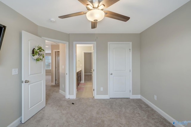 unfurnished bedroom with light carpet, ceiling fan, and ensuite bathroom