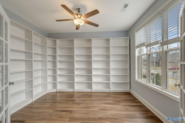 empty room featuring hardwood / wood-style flooring, french doors, and a wealth of natural light