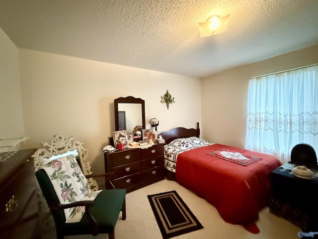 carpeted bedroom featuring a textured ceiling