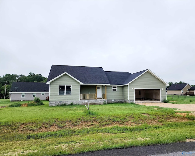 single story home featuring a garage, a front lawn, and a porch