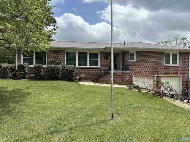 view of front of house with a garage, metal roof, and brick siding