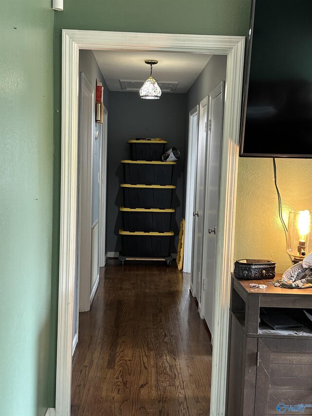 hall with dark wood-style floors and baseboards