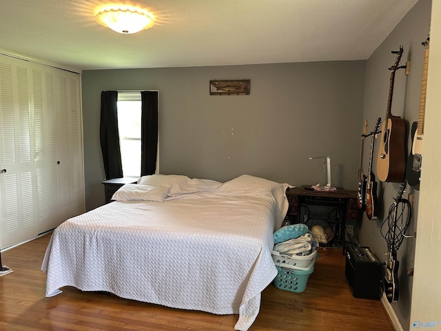 bedroom featuring wood finished floors and a closet