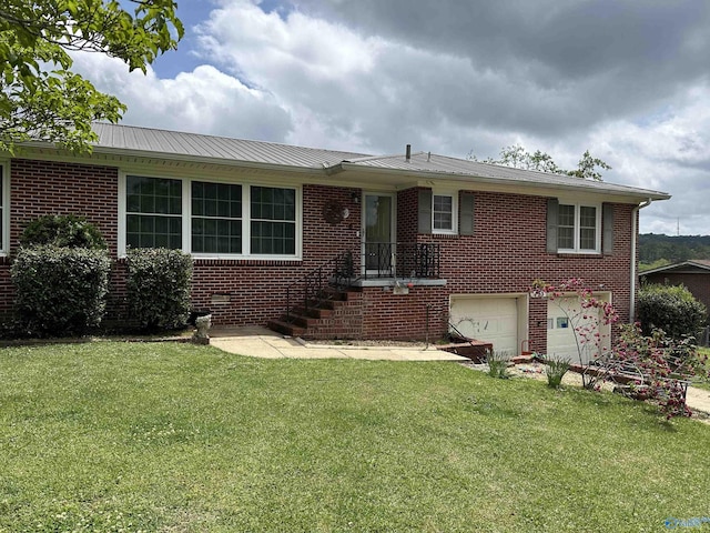 view of front of property with an attached garage, brick siding, a front yard, and metal roof