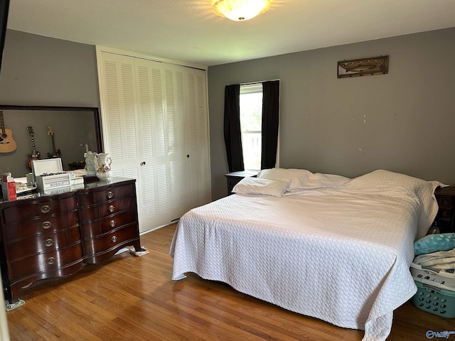 bedroom featuring a closet and wood finished floors