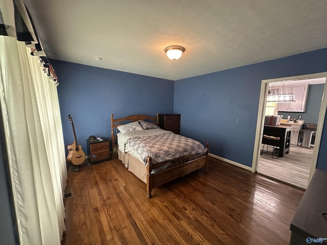 bedroom featuring wood finished floors and baseboards