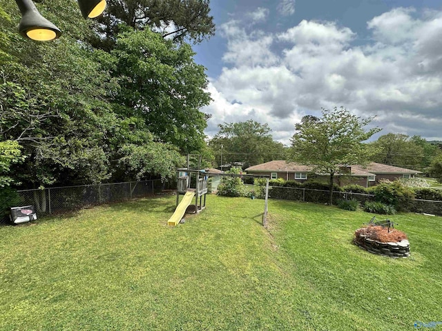 view of yard with a playground and an outdoor fire pit