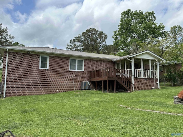 back of property featuring central air condition unit, a yard, brick siding, and stairway