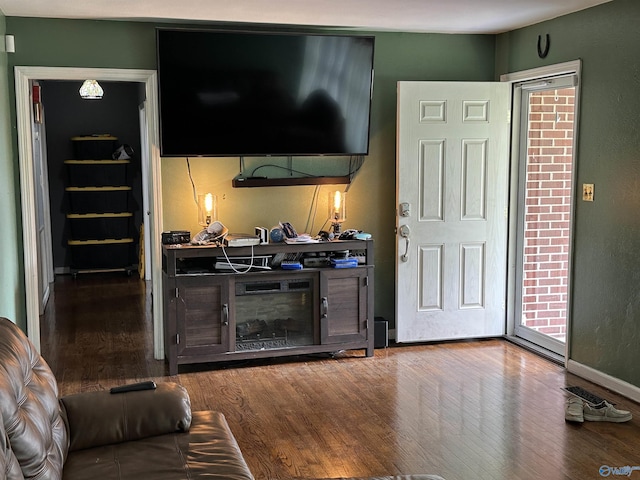 living area featuring wood finished floors and baseboards