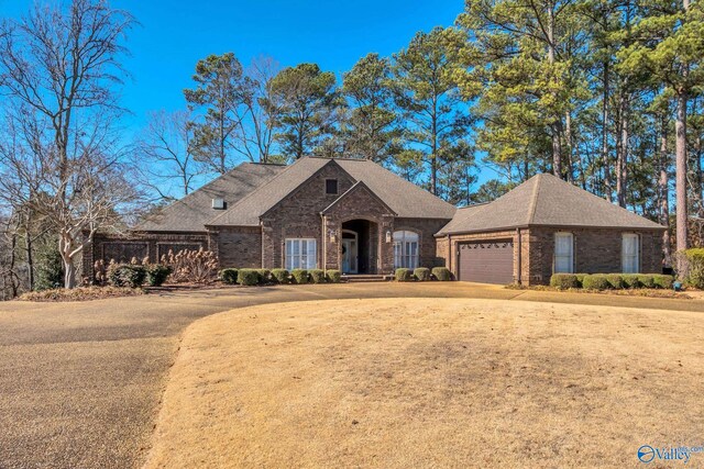 view of front of house with a garage and a front lawn