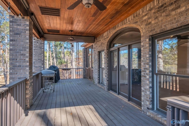 deck with visible vents, area for grilling, and ceiling fan