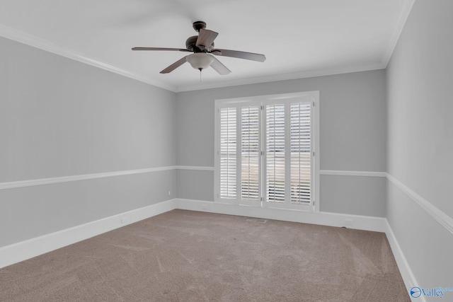 carpeted empty room featuring a ceiling fan, baseboards, and ornamental molding