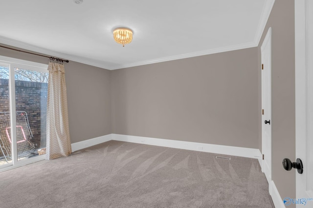 carpeted spare room featuring baseboards and crown molding