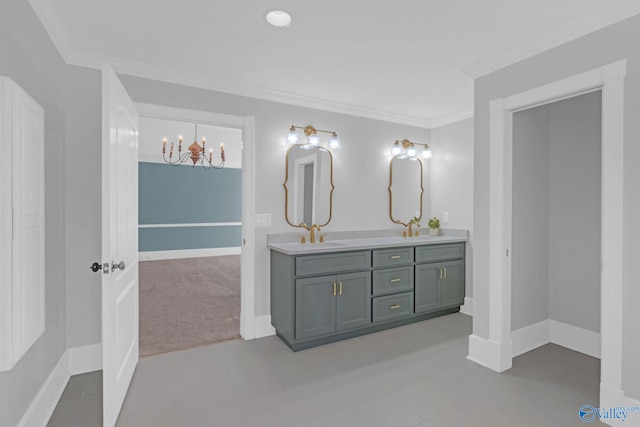 full bath with double vanity, an inviting chandelier, crown molding, and a sink