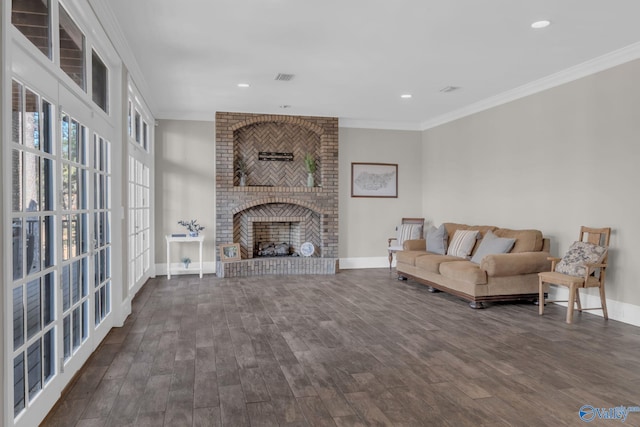 living room featuring a fireplace, wood finished floors, baseboards, and ornamental molding