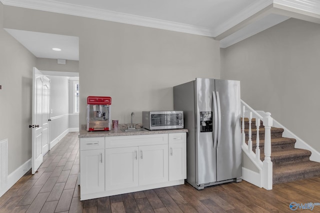 kitchen featuring a sink, white cabinets, stainless steel appliances, and dark wood-style flooring