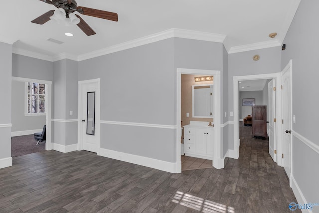 unfurnished room with baseboards, visible vents, dark wood-style flooring, and ornamental molding