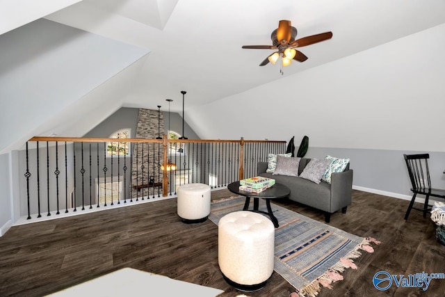 sitting room with baseboards, lofted ceiling, wood finished floors, and a ceiling fan