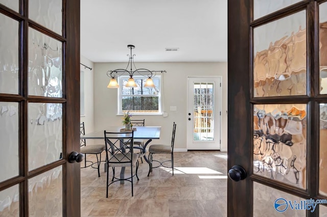dining space featuring baseboards and visible vents