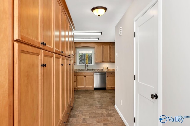 hall with a sink and baseboards
