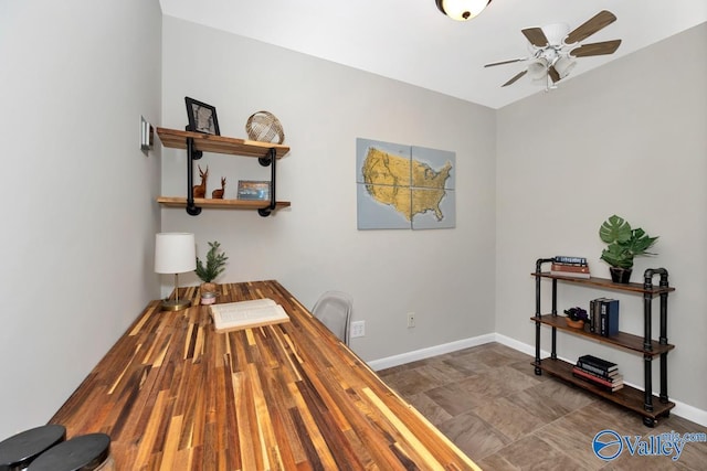 dining space featuring a ceiling fan and baseboards