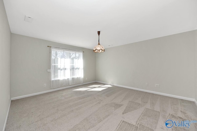 carpeted empty room with baseboards