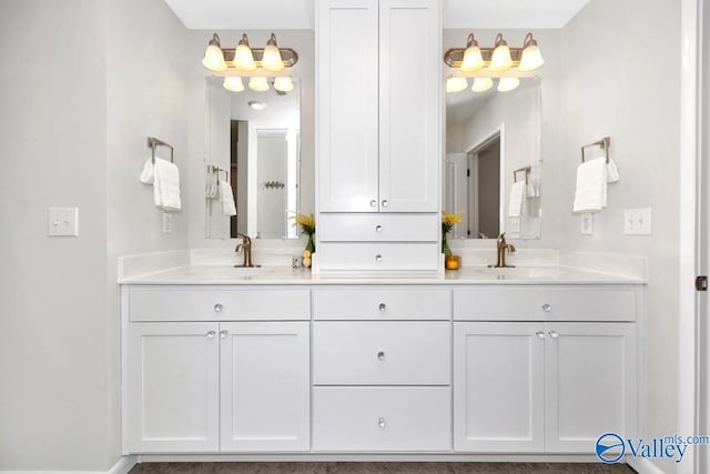 full bathroom with a sink and double vanity