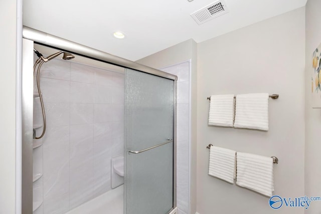 bathroom featuring recessed lighting, visible vents, and a shower stall