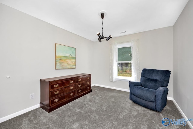 living area featuring visible vents, baseboards, and carpet floors
