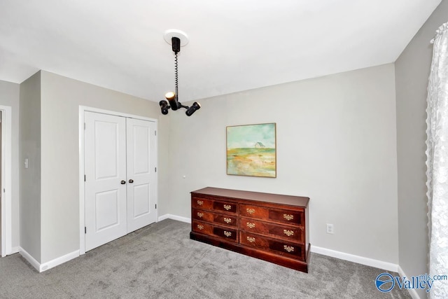 unfurnished bedroom featuring a closet, carpet flooring, and baseboards