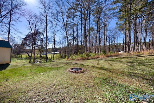 view of yard with an outdoor fire pit