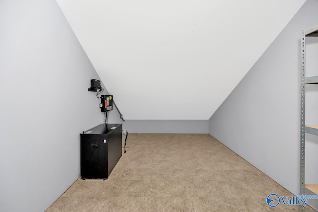 bonus room with vaulted ceiling and carpet floors