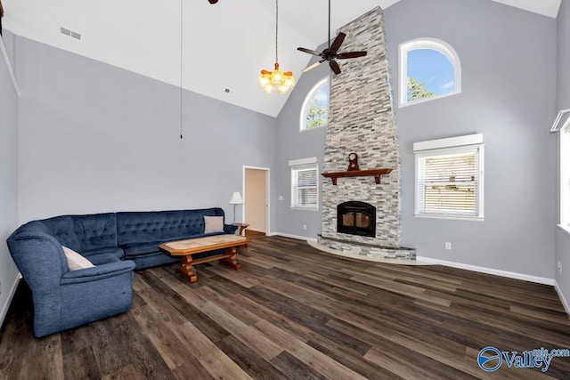 living area featuring visible vents, a healthy amount of sunlight, wood finished floors, and ceiling fan with notable chandelier