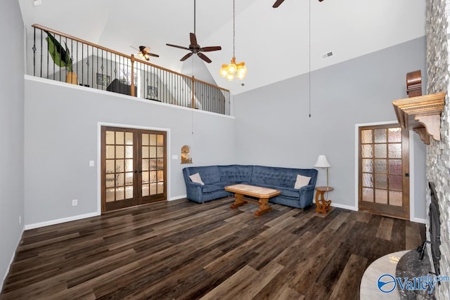 living area with visible vents, ceiling fan, french doors, wood finished floors, and high vaulted ceiling