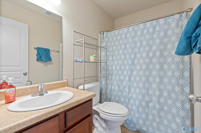 bathroom featuring toilet and vanity