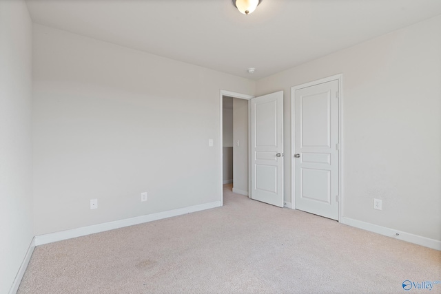 unfurnished bedroom with light colored carpet