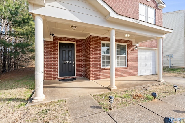 entrance to property with a garage and a porch