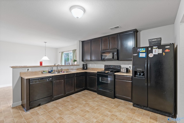 kitchen featuring black appliances, dark brown cabinets, sink, and pendant lighting