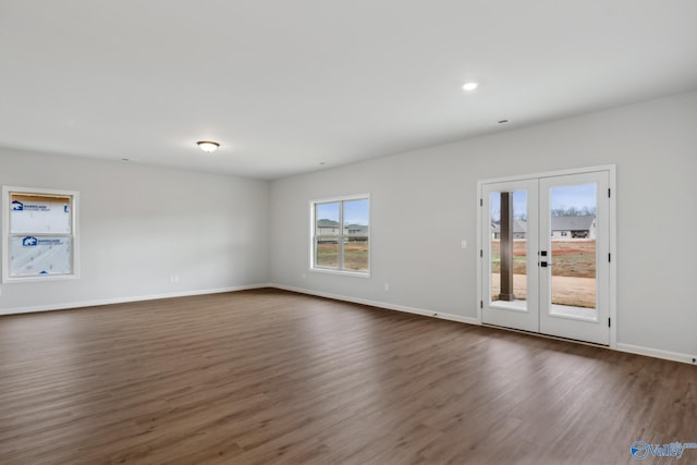 spare room with french doors and dark hardwood / wood-style floors