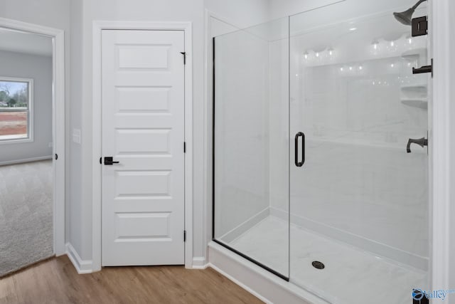 bathroom featuring hardwood / wood-style floors and walk in shower