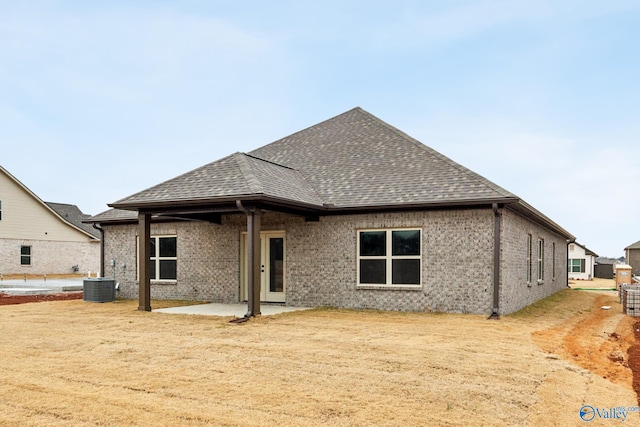 rear view of house with a patio and central AC unit