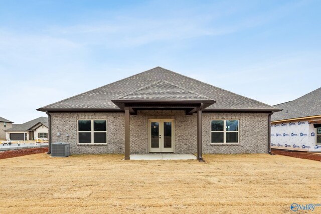 rear view of property featuring a patio area, french doors, and cooling unit