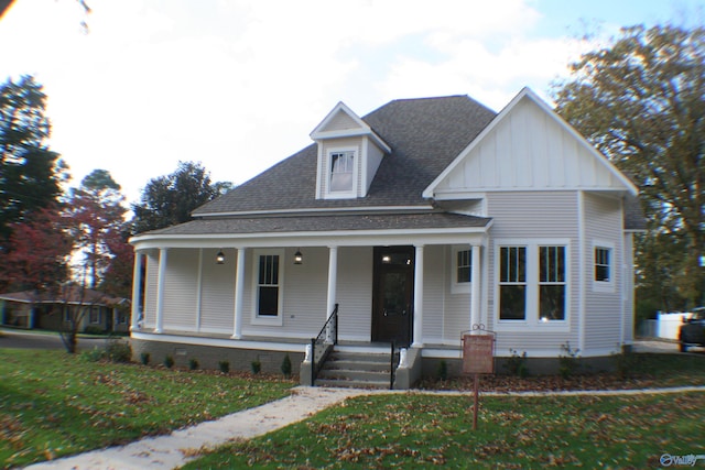 view of front of house featuring covered porch and a front lawn