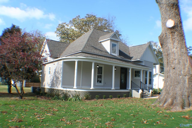 view of front of home with a porch and a front lawn