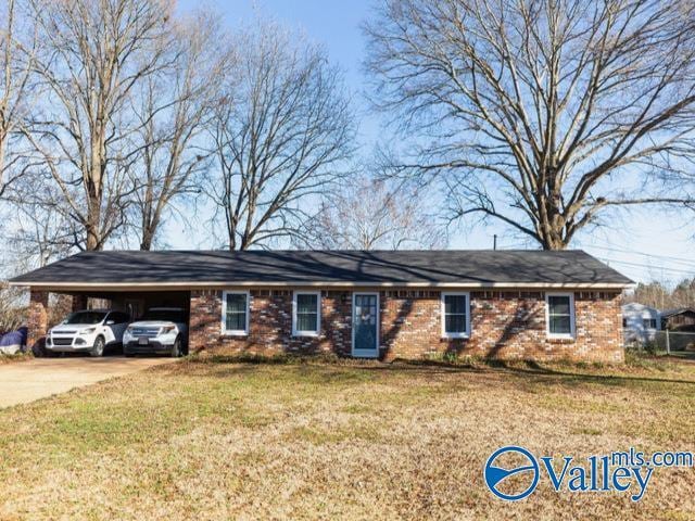 single story home with a front lawn and a carport