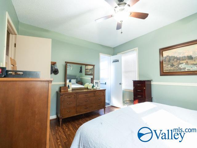 bedroom with ceiling fan and dark wood-type flooring